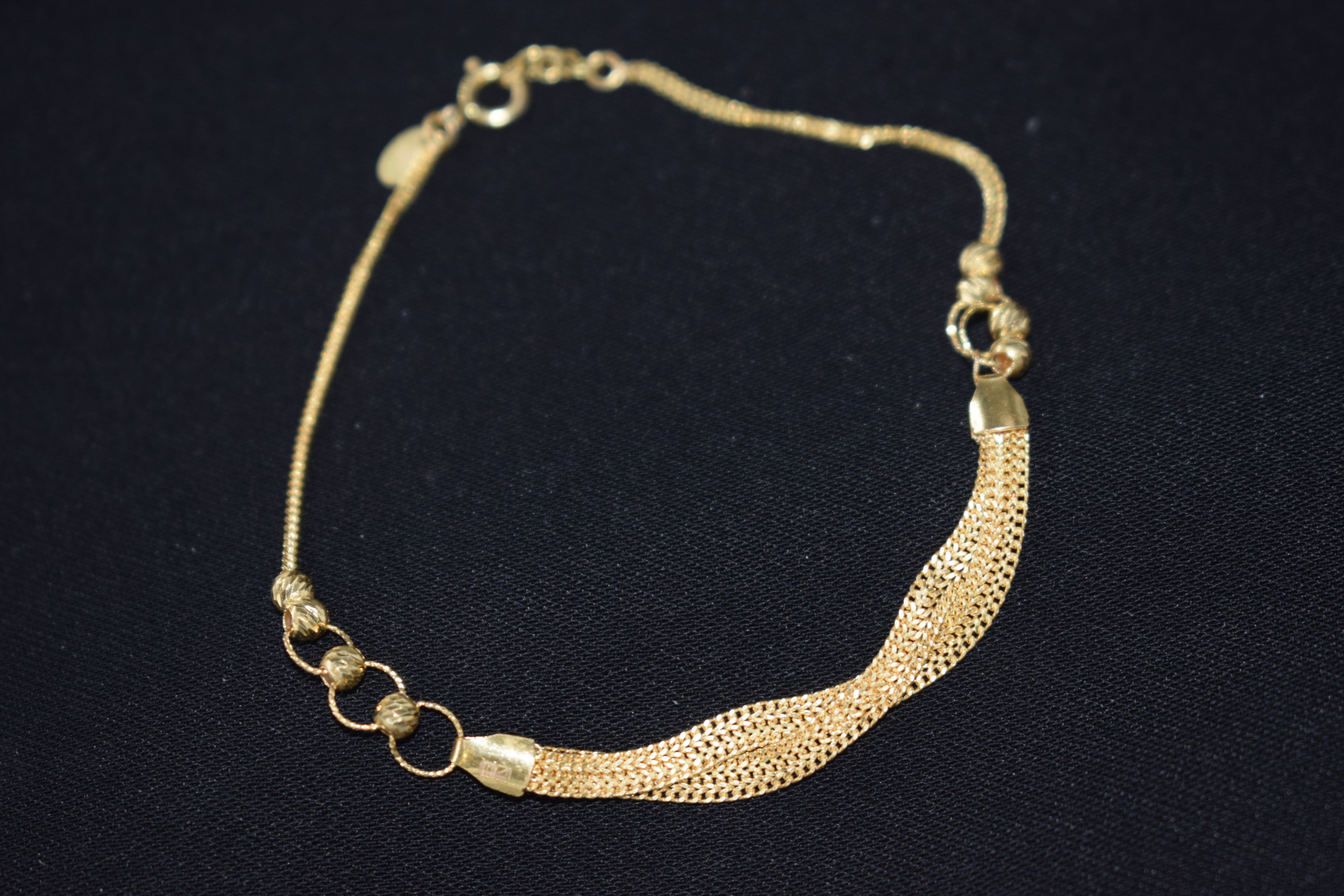 Gold bracelet on a black background