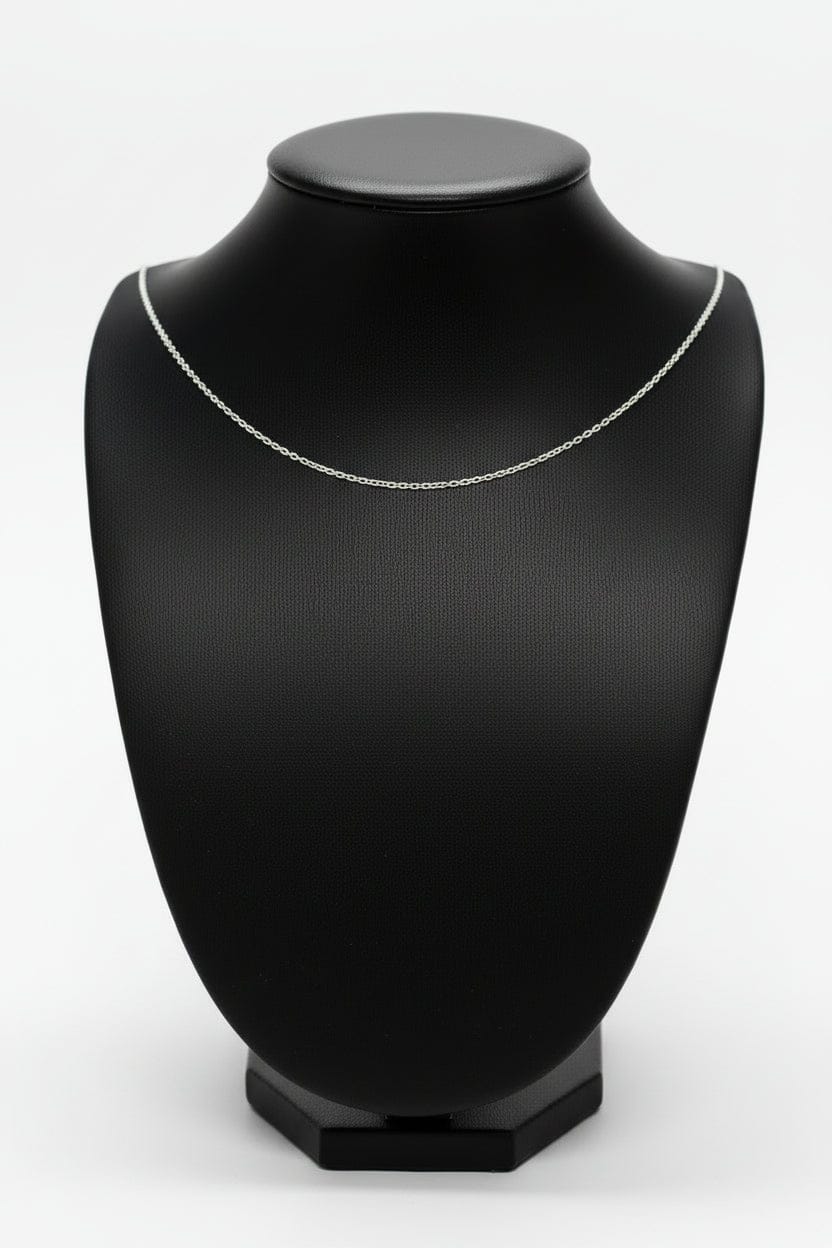 Silver chain necklace on a black mannequin bust