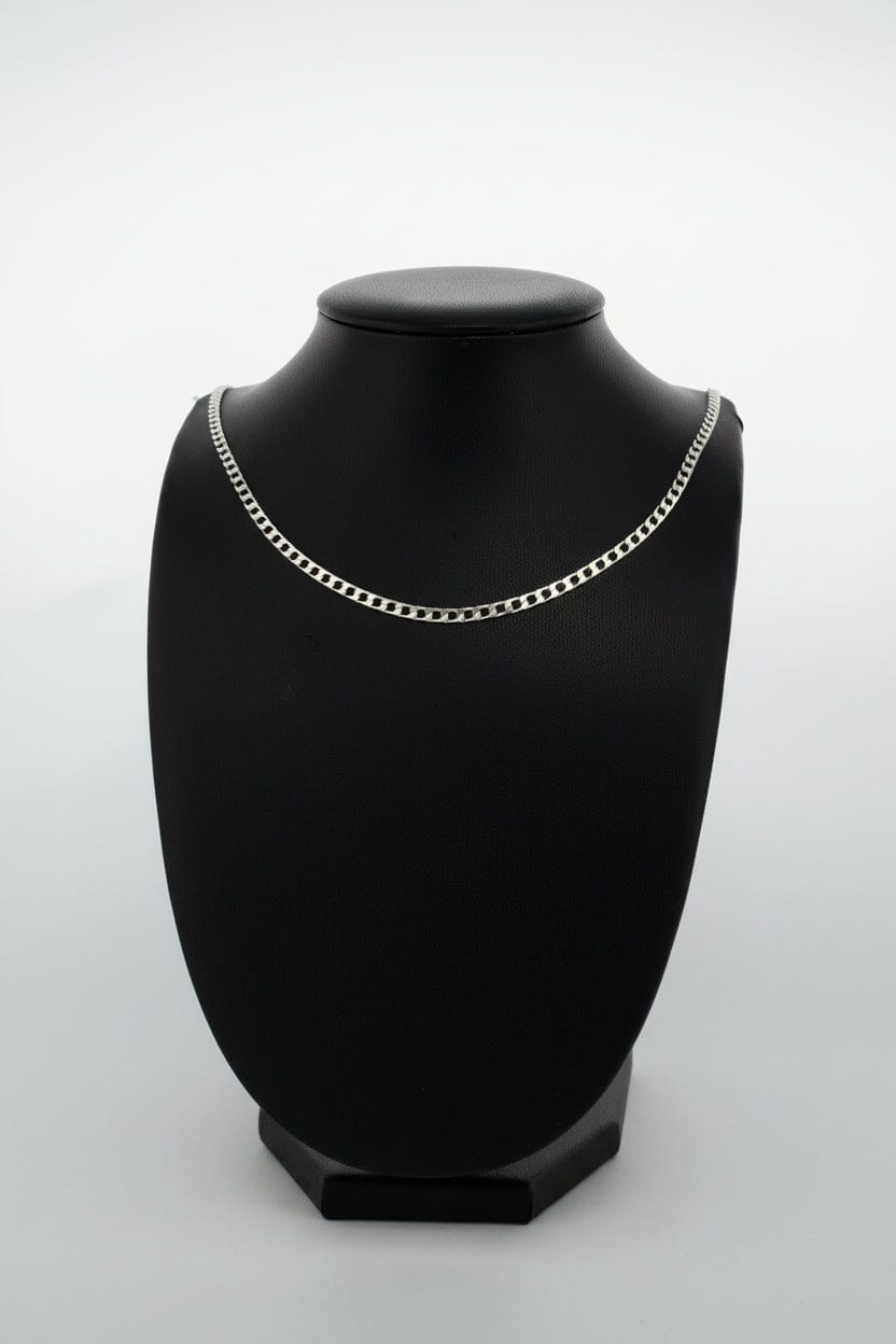 Silver chain necklace on a black mannequin against a neutral background
