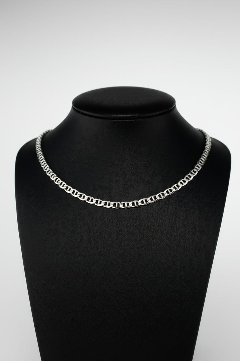 Silver chain necklace on a black mannequin neck