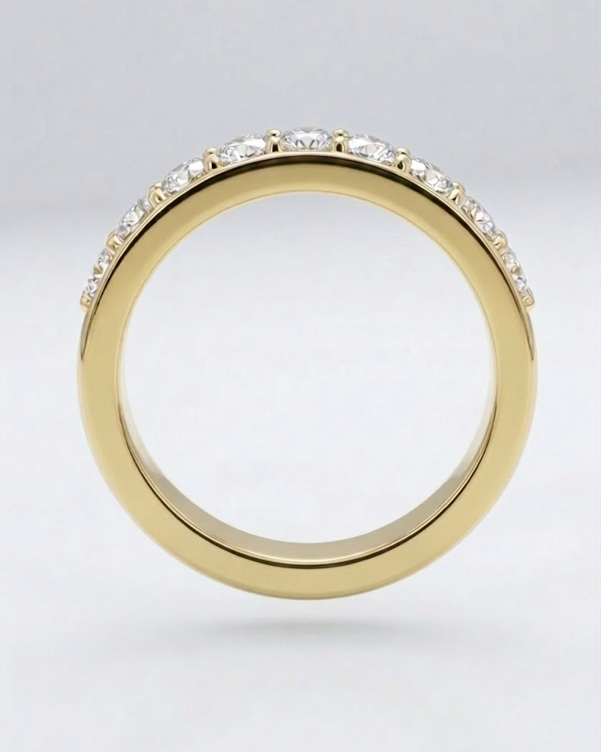 Gold ring with small diamonds on a light gray background