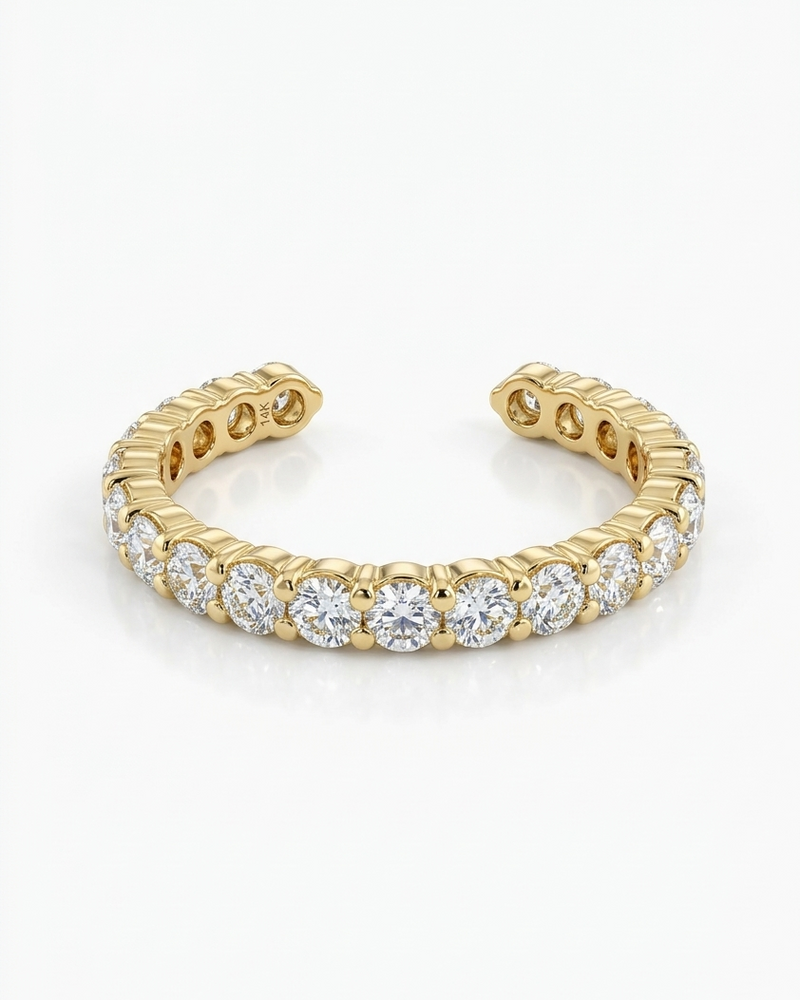 Gold ring with embedded diamonds on a white background