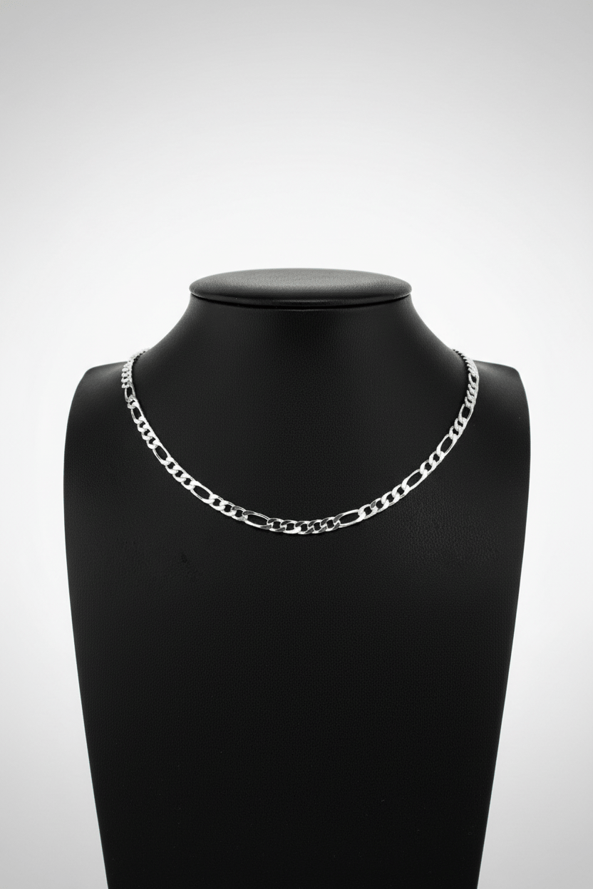 Silver chain necklace on a black mannequin bust against a white background