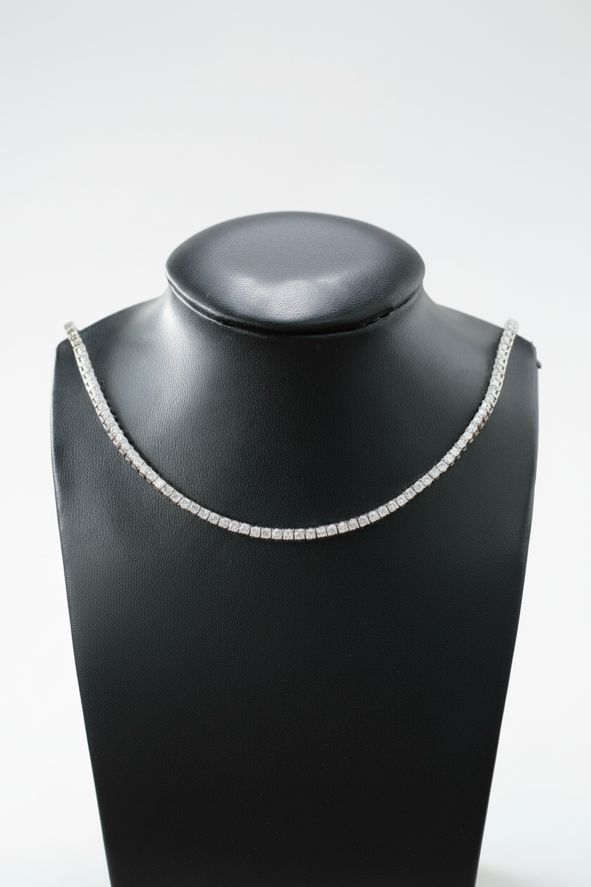 Silver necklace on a black mannequin bust