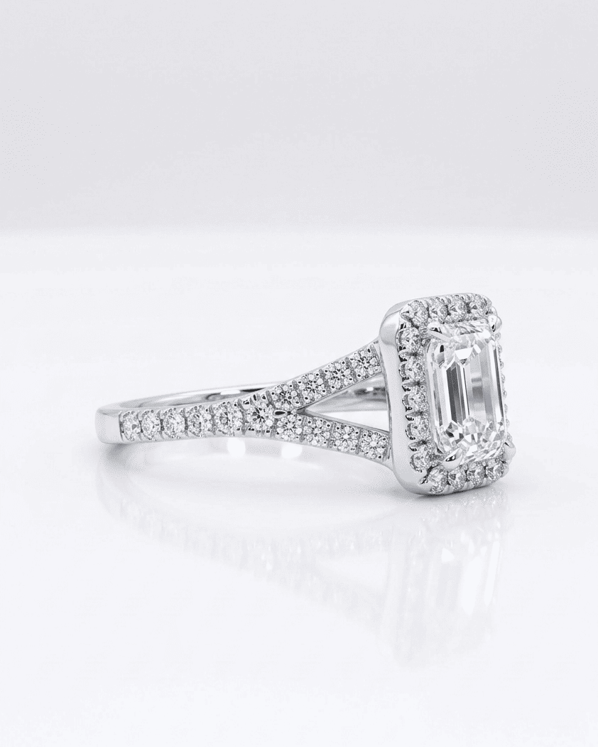 Diamond ring with a rectangular center stone on a white background
