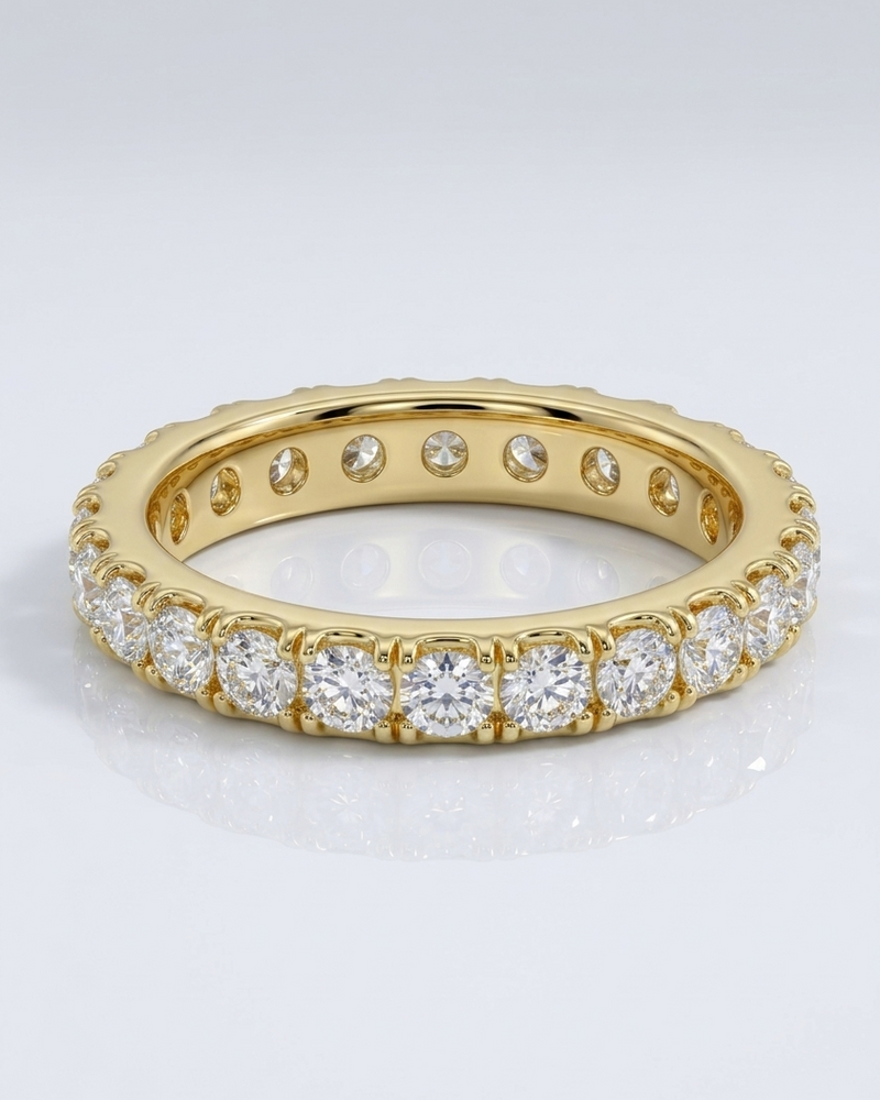 Gold ring with diamonds on a light gray background