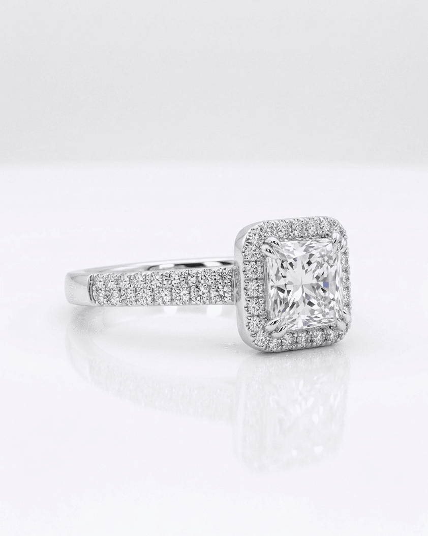 Diamond ring with a large central gemstone and smaller stones on a white background