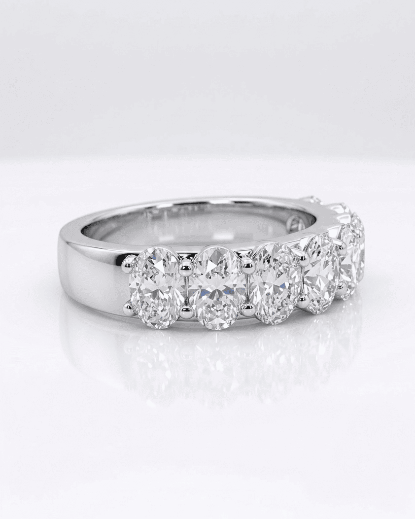 Silver ring with multiple diamonds on a white background