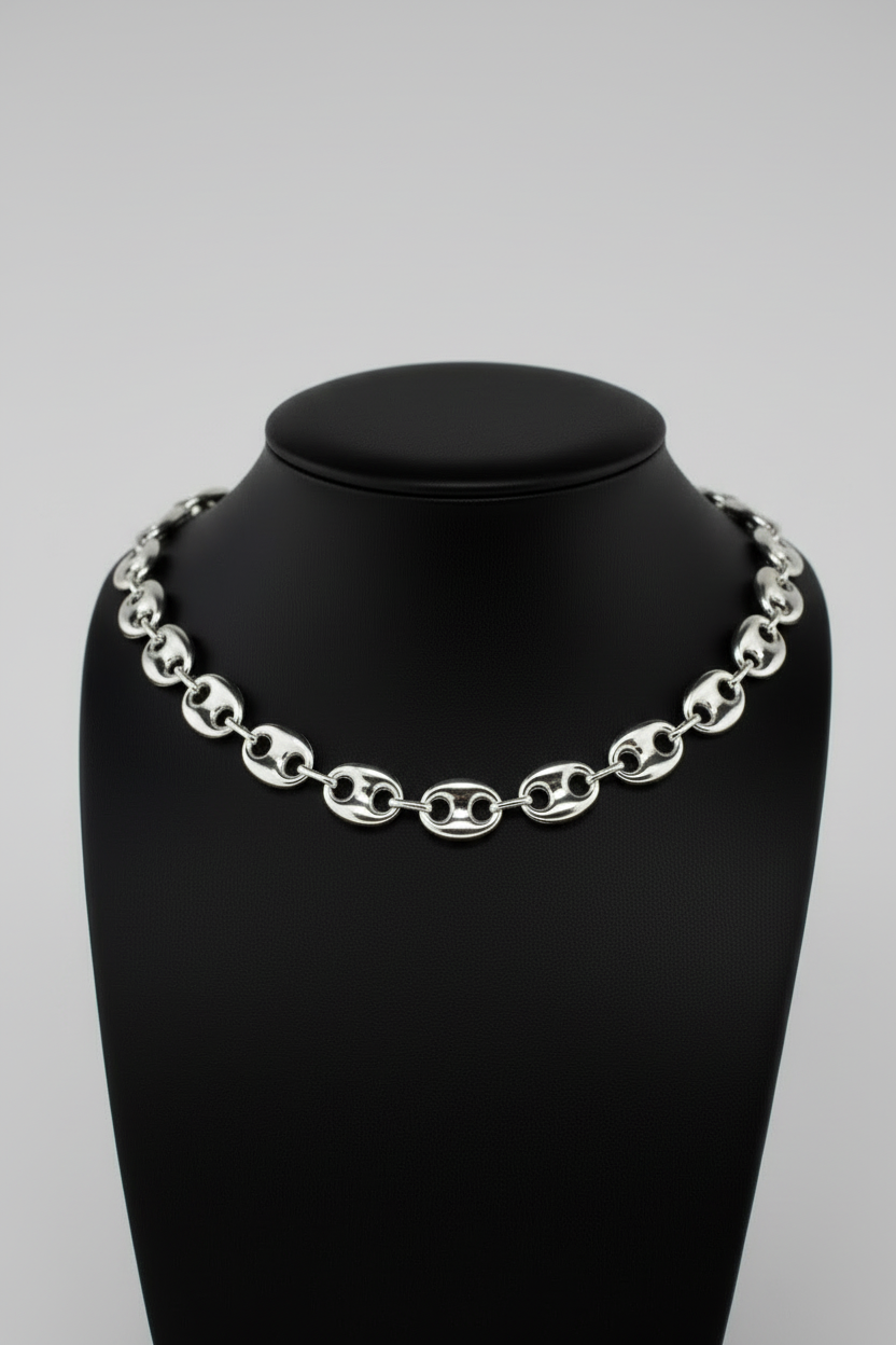 Silver chain necklace on a black mannequin bust