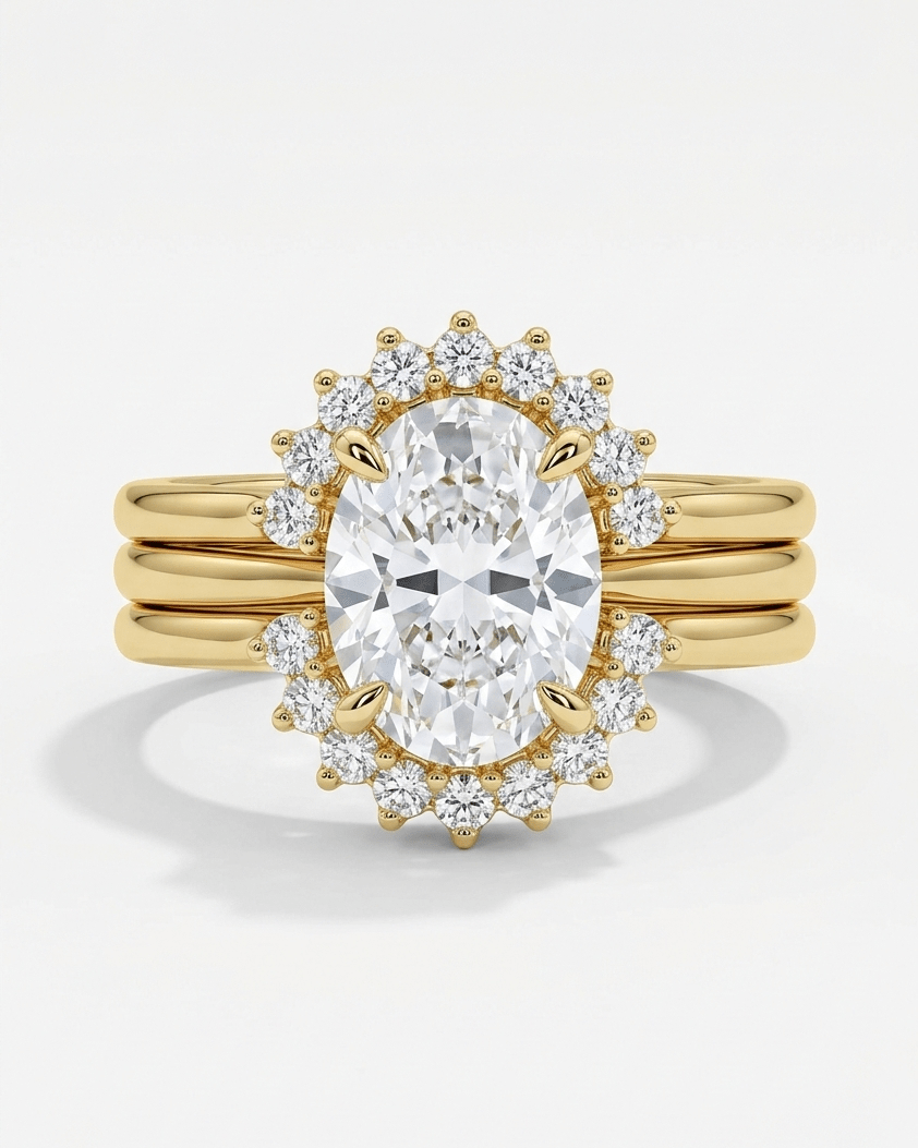 Gold ring with a large diamond and smaller diamonds around on a white background
