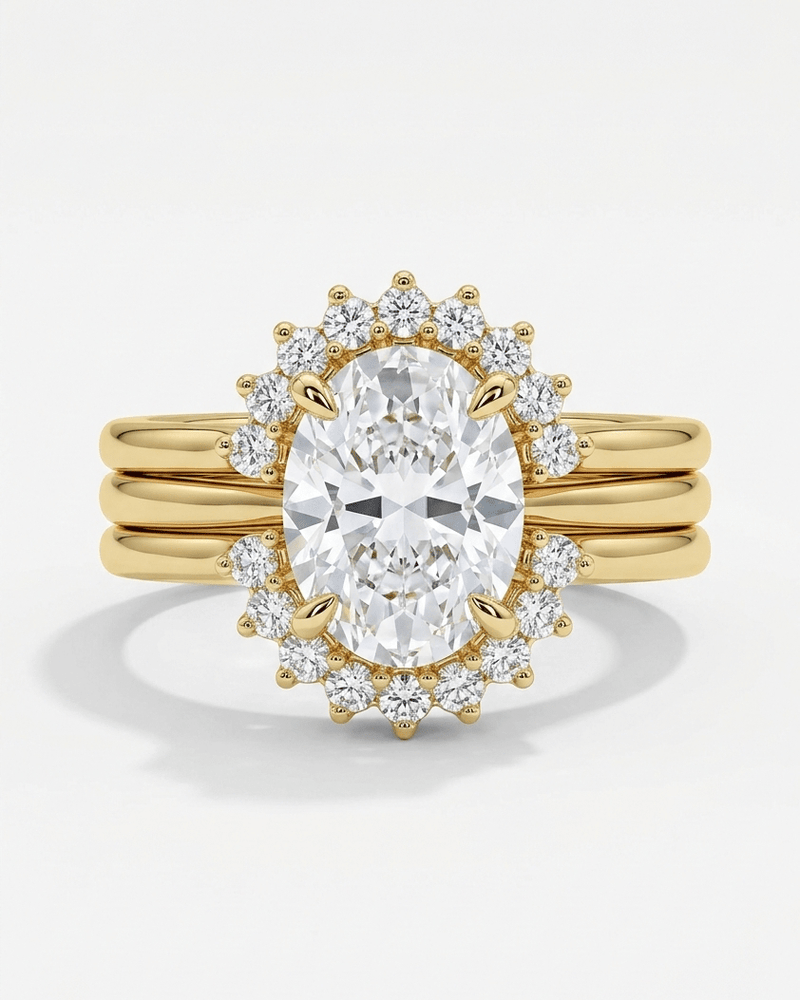 Gold ring with a large diamond and smaller diamonds around on a white background