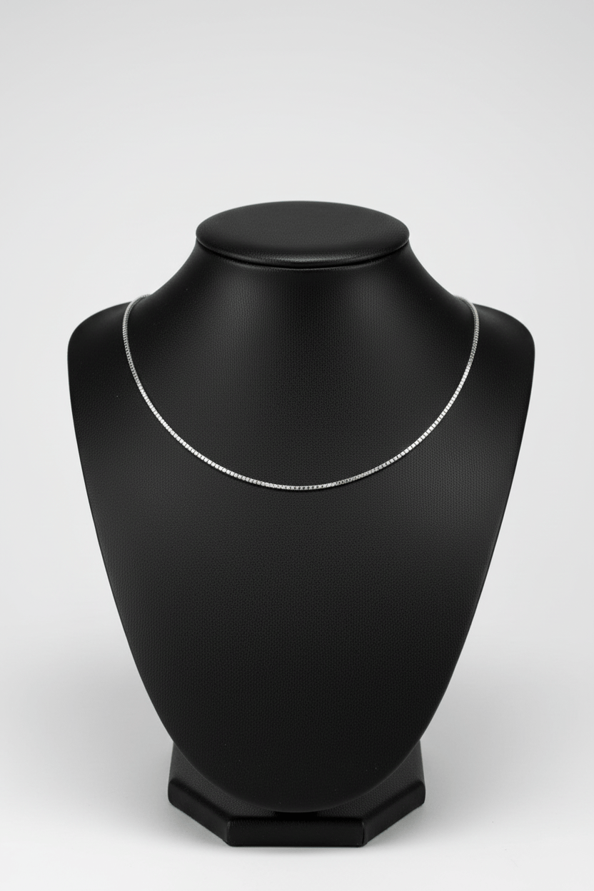 Silver necklace on a black mannequin neck