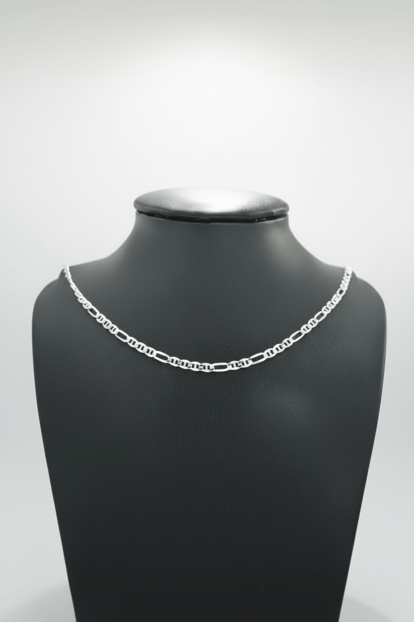 Silver chain necklace on a black mannequin bust against a white background