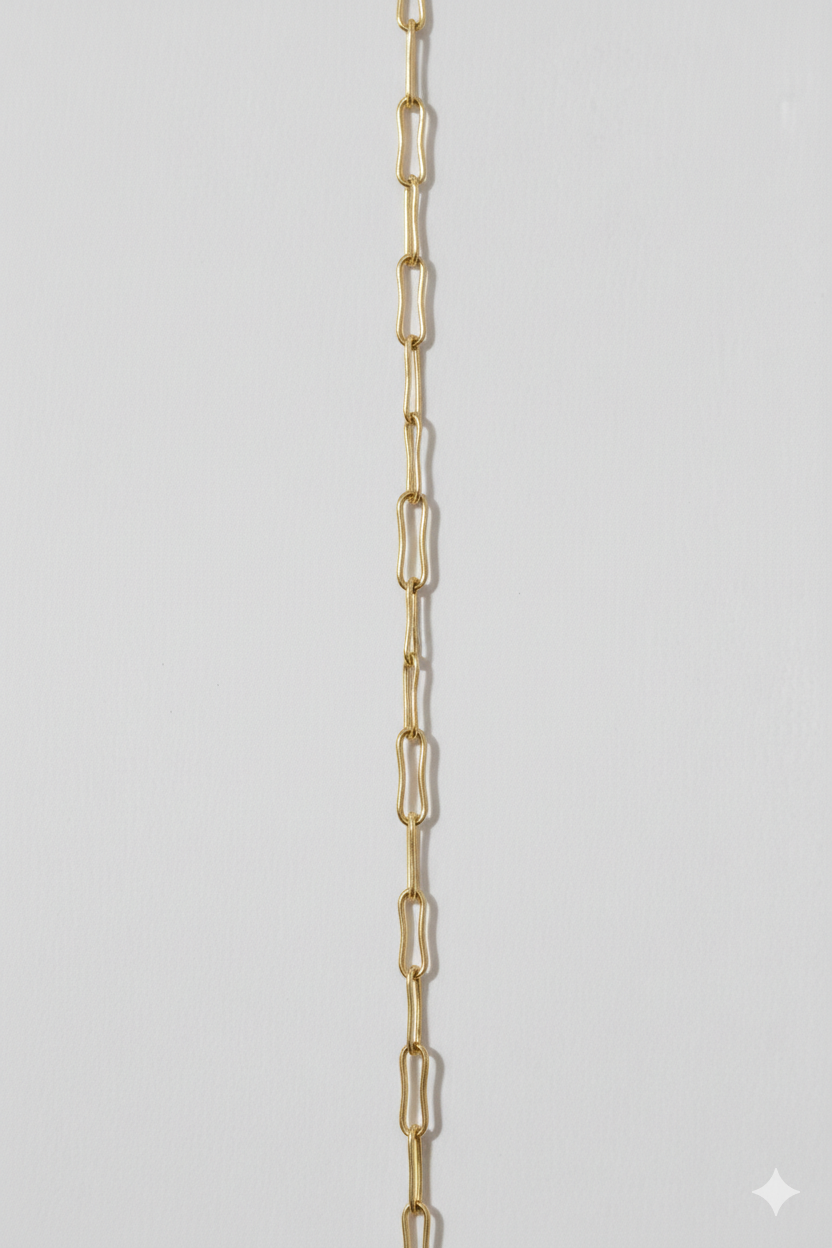 Gold chain on a light gray background