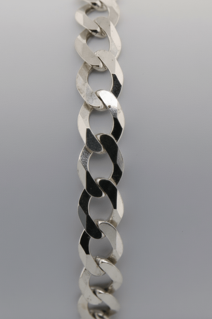 Silver chain bracelet on a light gray background