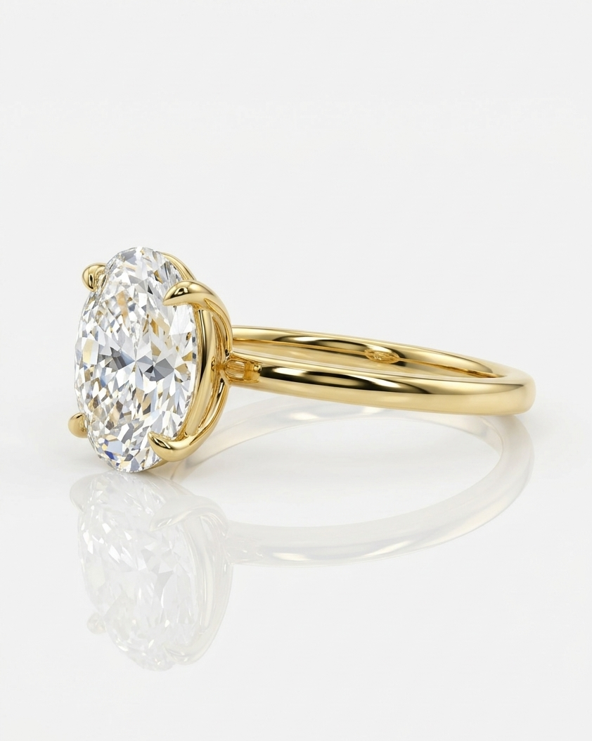 Gold ring with a heart-shaped diamond on a white background