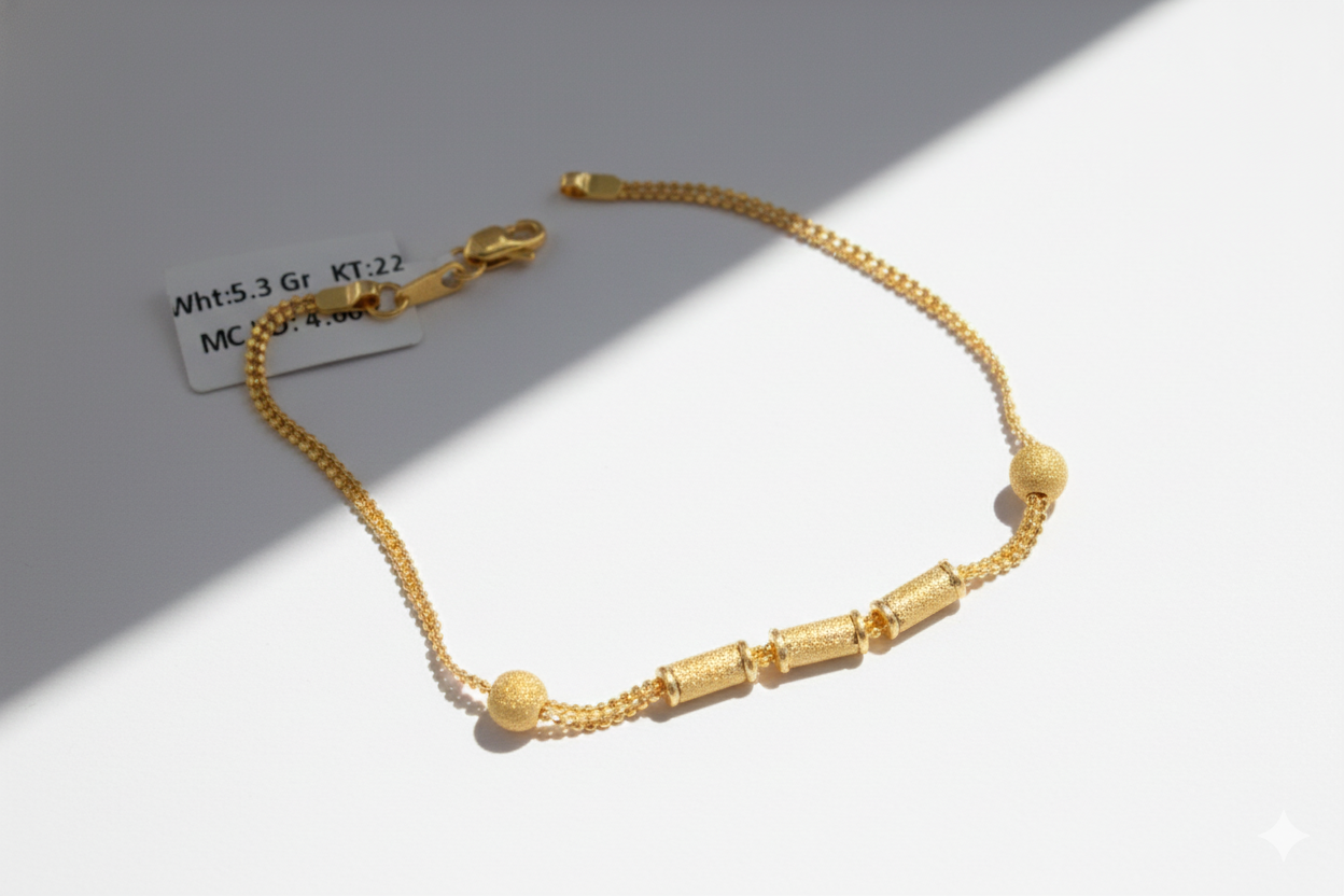 Gold bracelet on a light gray background with weight and karat information.