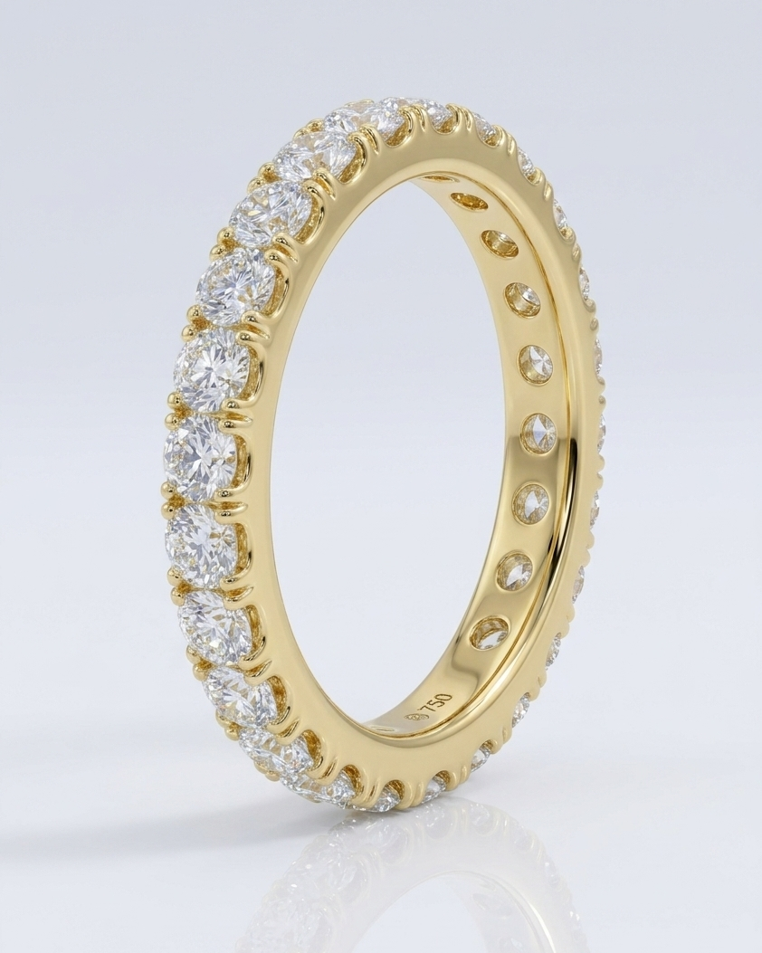 Gold ring with diamond accents on a light gray background