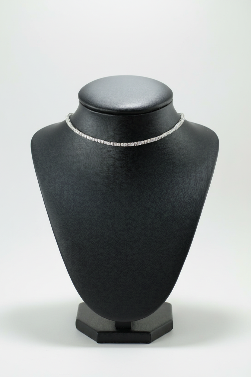 Diamond necklace on a black mannequin bust with a white background