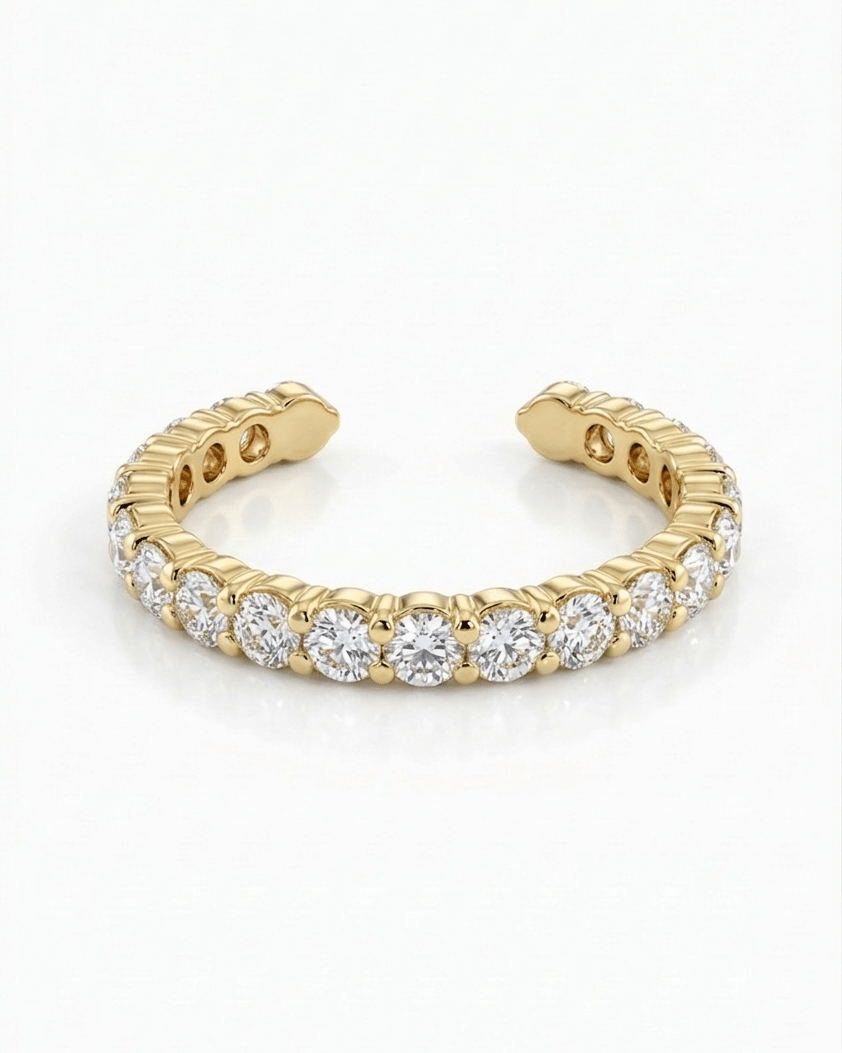 Gold ring with embedded diamonds on a white background