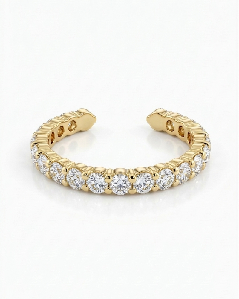 Gold ring with embedded diamonds on a white background