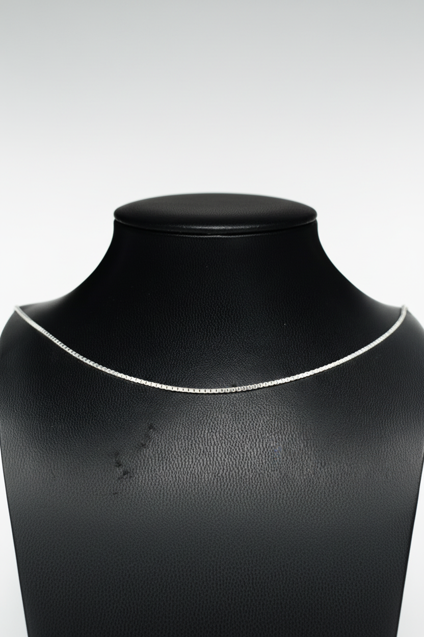 Silver necklace on a black mannequin bust