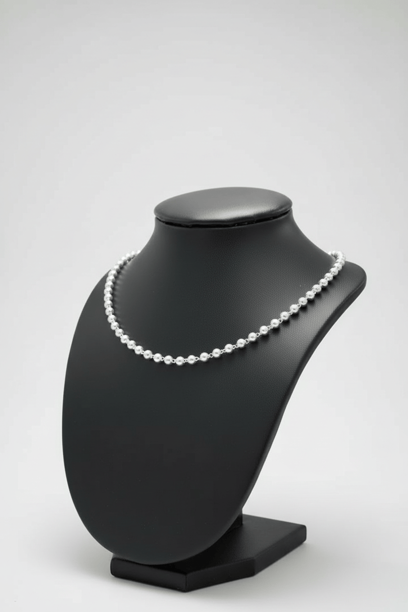 Pearl necklace on a black mannequin bust