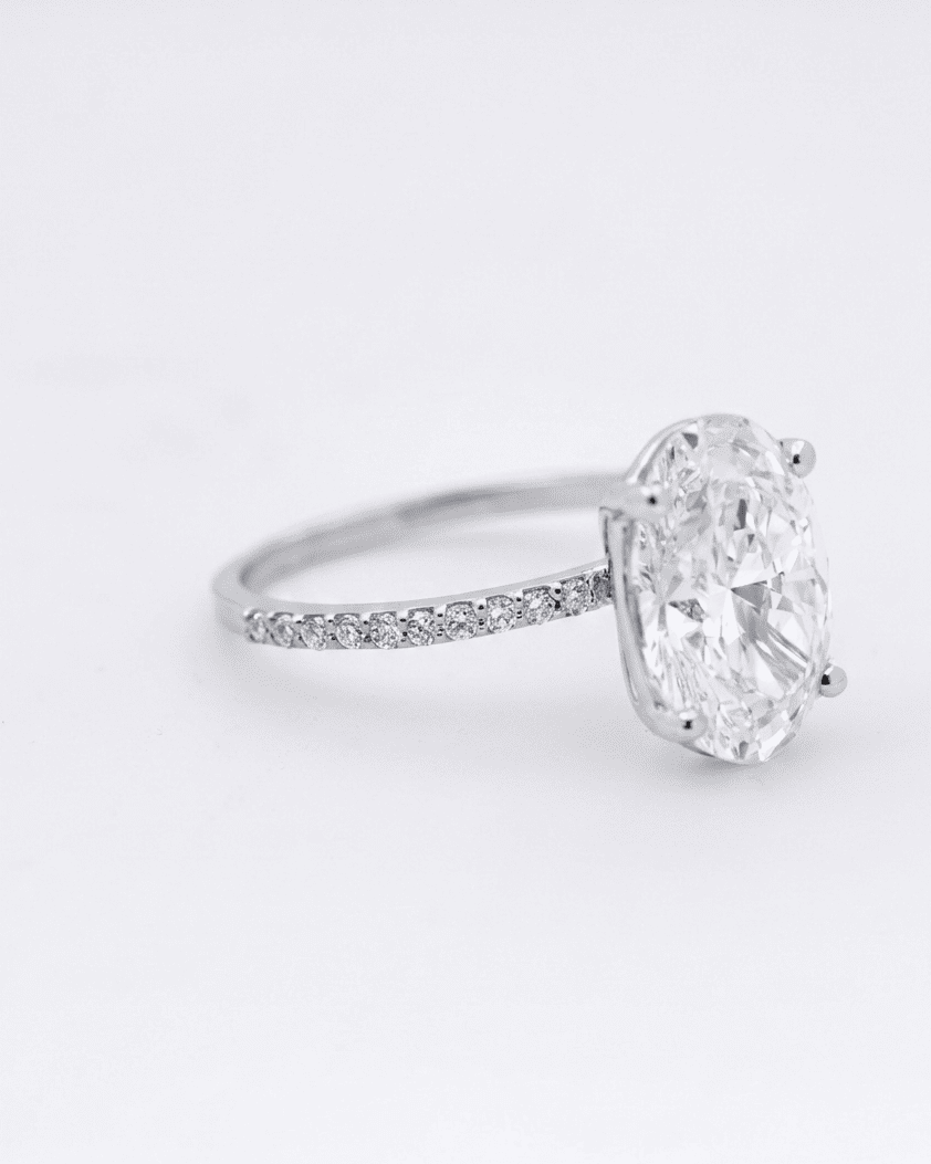 Diamond ring with a large central gemstone on a white background