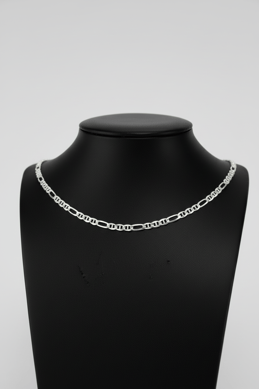 Silver chain necklace on a black mannequin bust