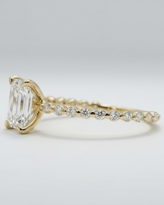Gold ring with a diamond on a light gray background