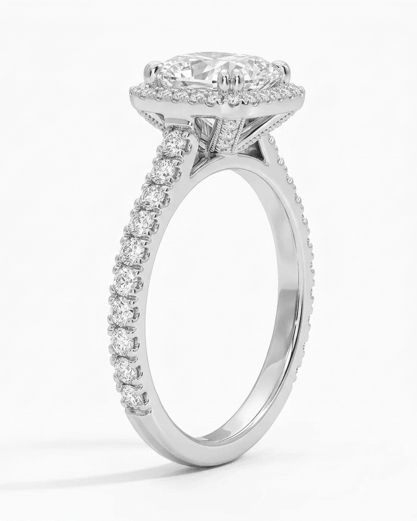 Diamond ring with a halo and pavé setting on a white background