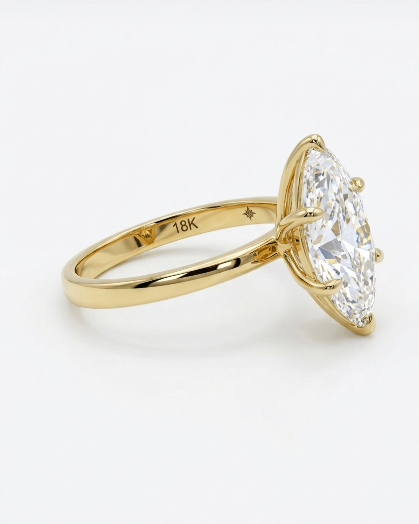 Gold ring with a large diamond on a white background