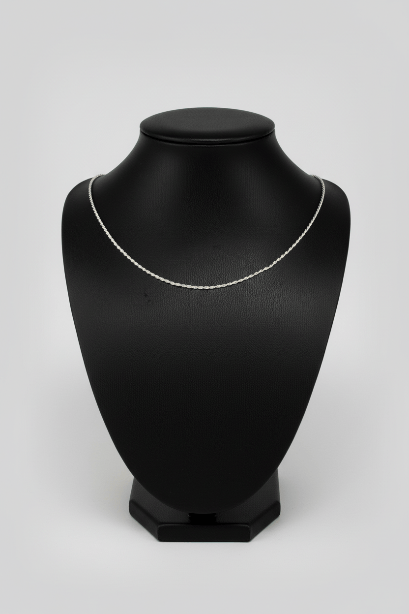 Silver necklace on a black mannequin bust