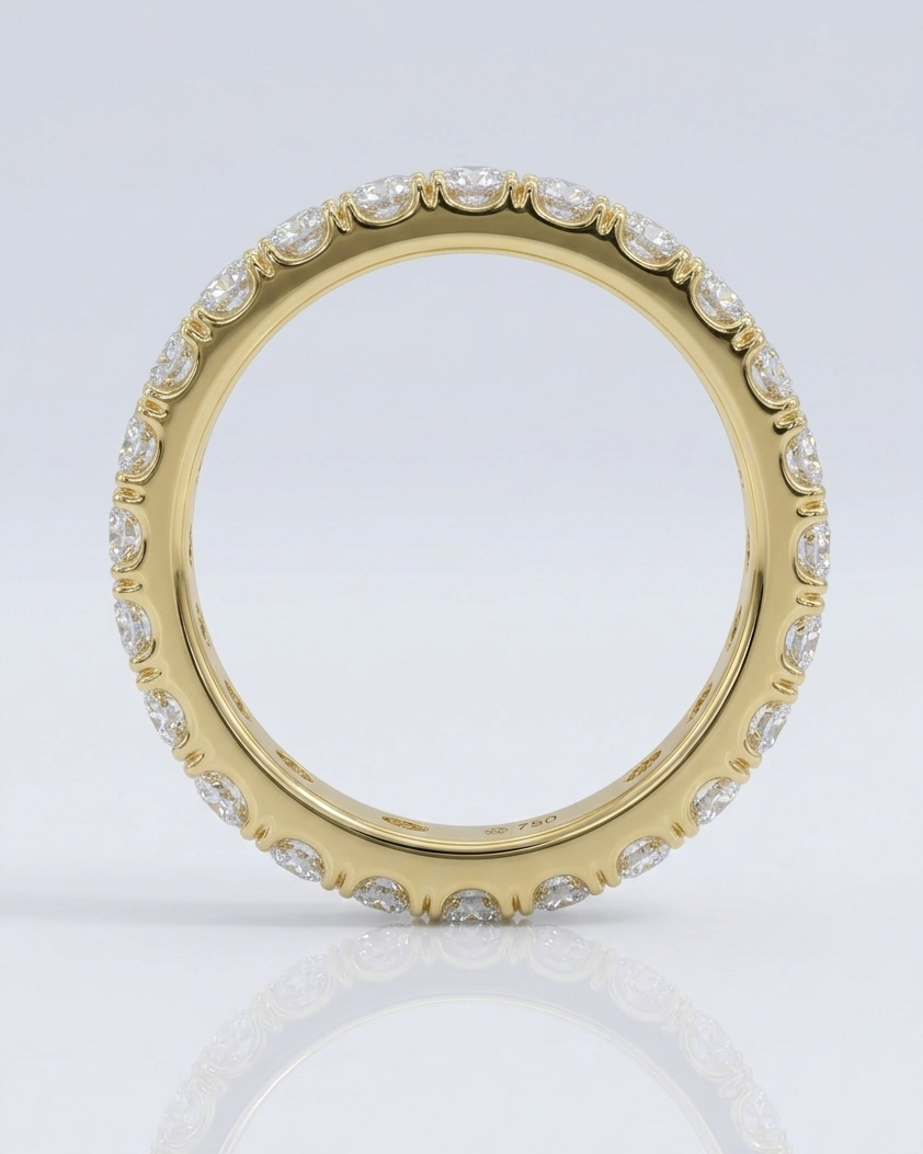 Gold ring with embedded diamonds on a light gray background