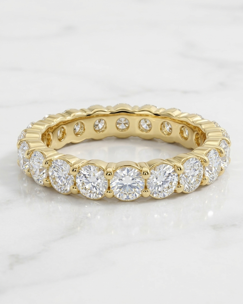 Gold ring with diamonds on a light gray background