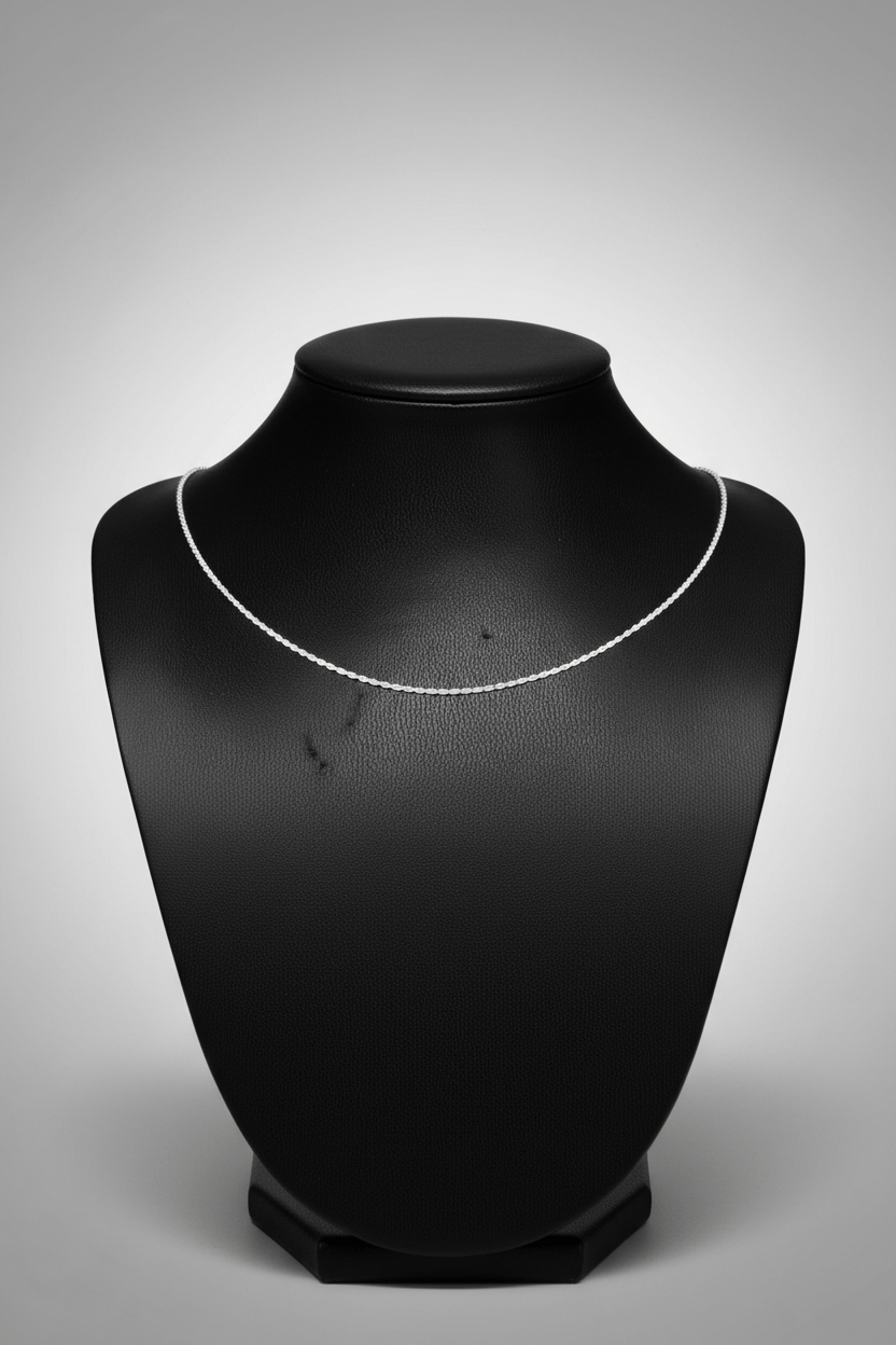 Silver necklace on a black mannequin neck