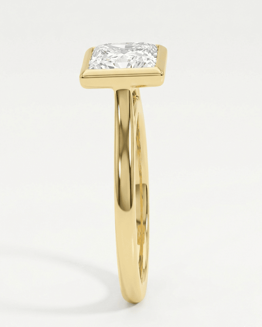 Gold ring with a diamond on a white background