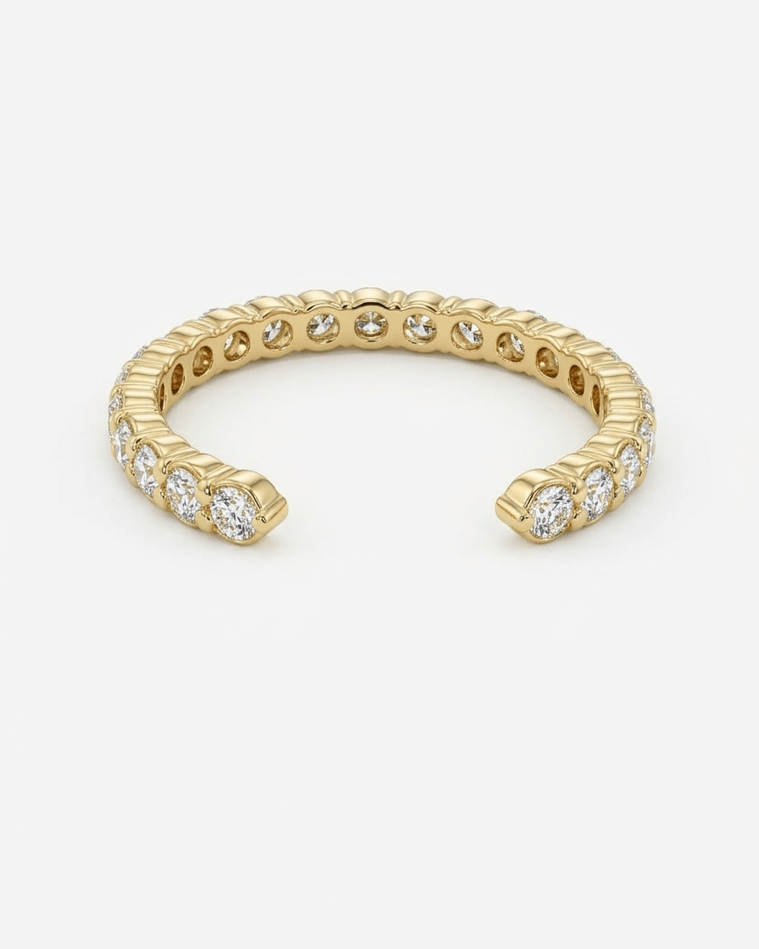 Gold ring with embedded stones on a white background