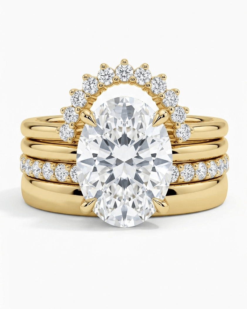 Gold ring with a large diamond and smaller diamonds on a white background
