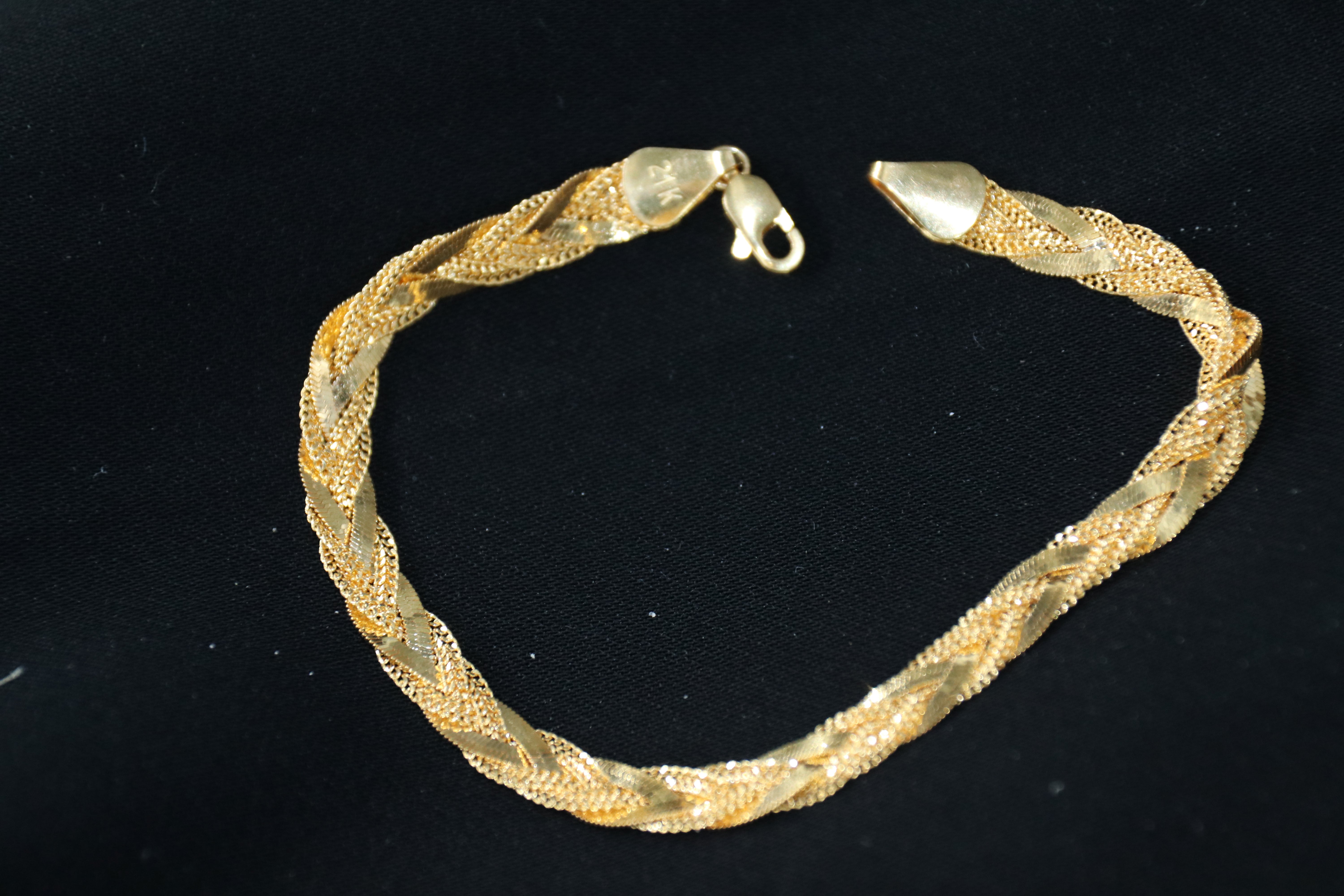 Gold bracelet on a black background