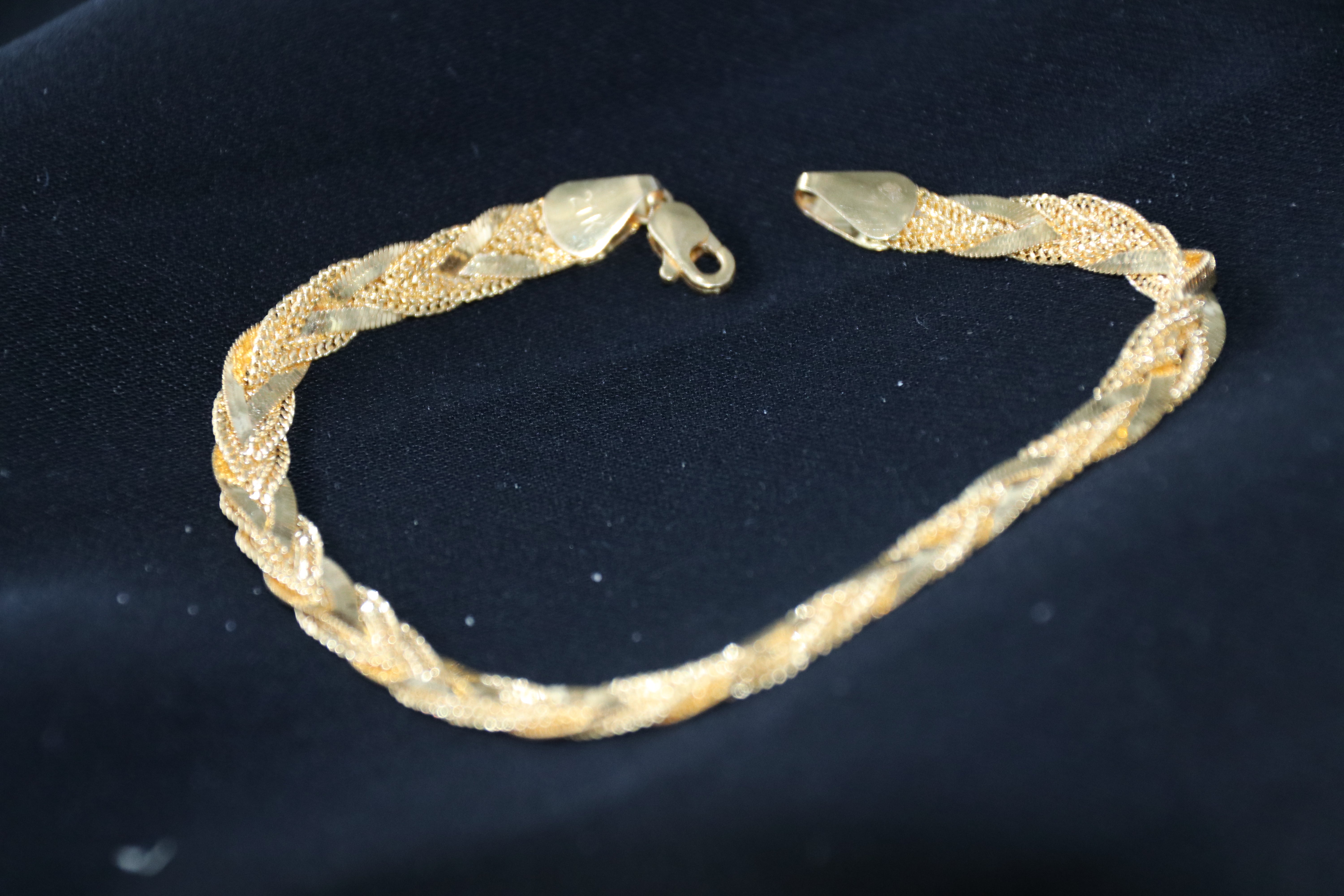 Gold bracelet on a dark background