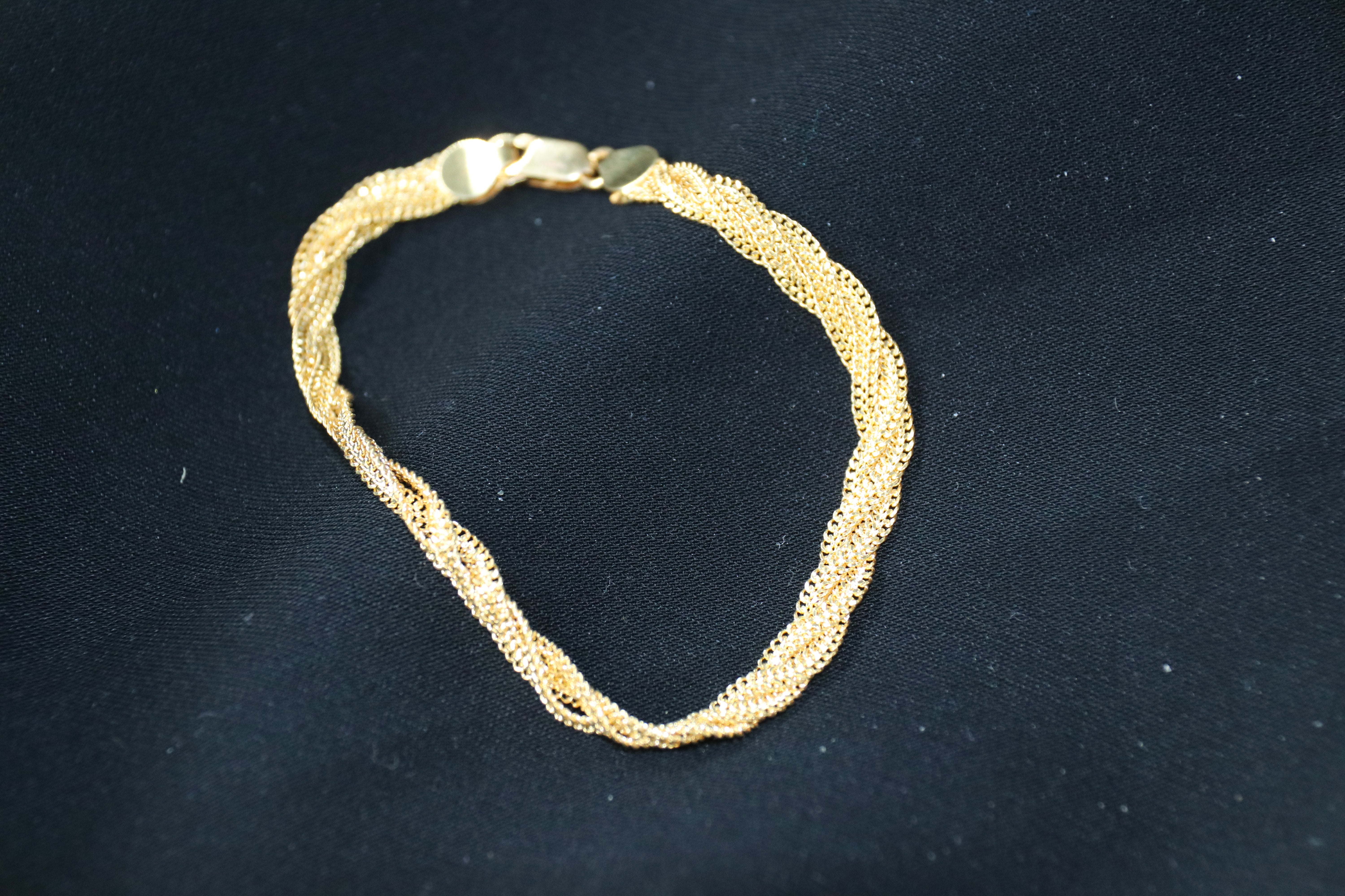 Gold bracelet on a black background