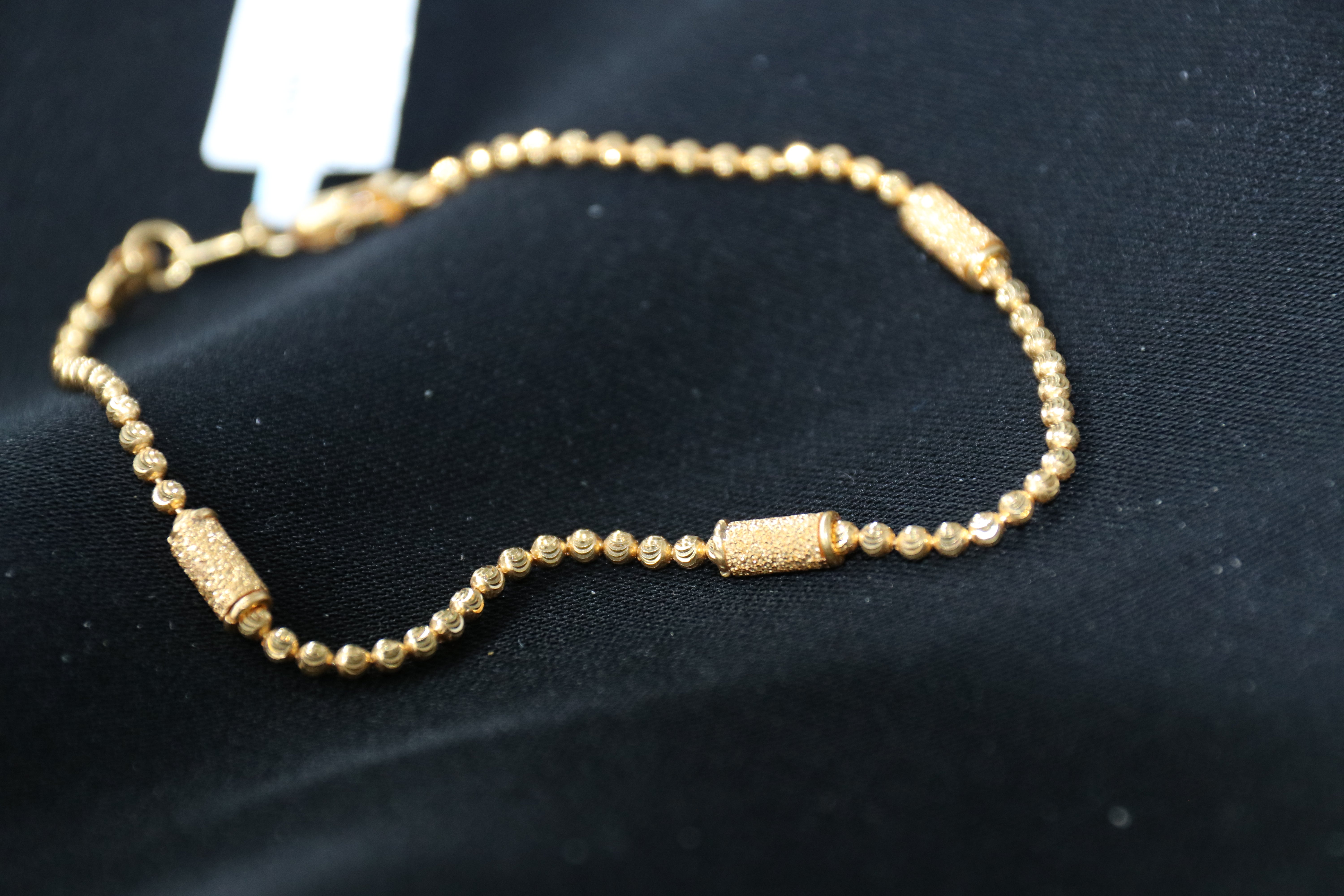Gold bracelet on a black background