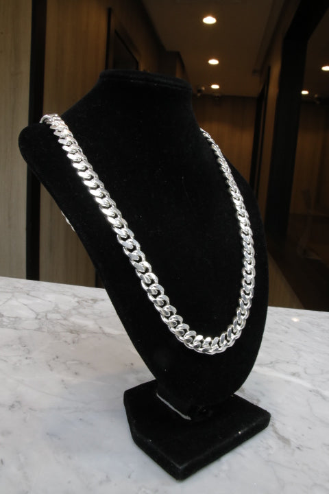 Black headband with a silver chain on a marble surface