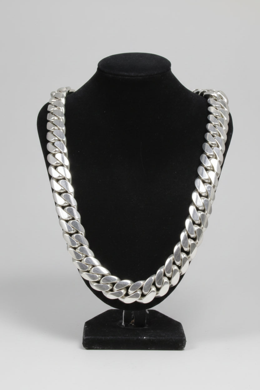 Black headband with silver chain design on a white background