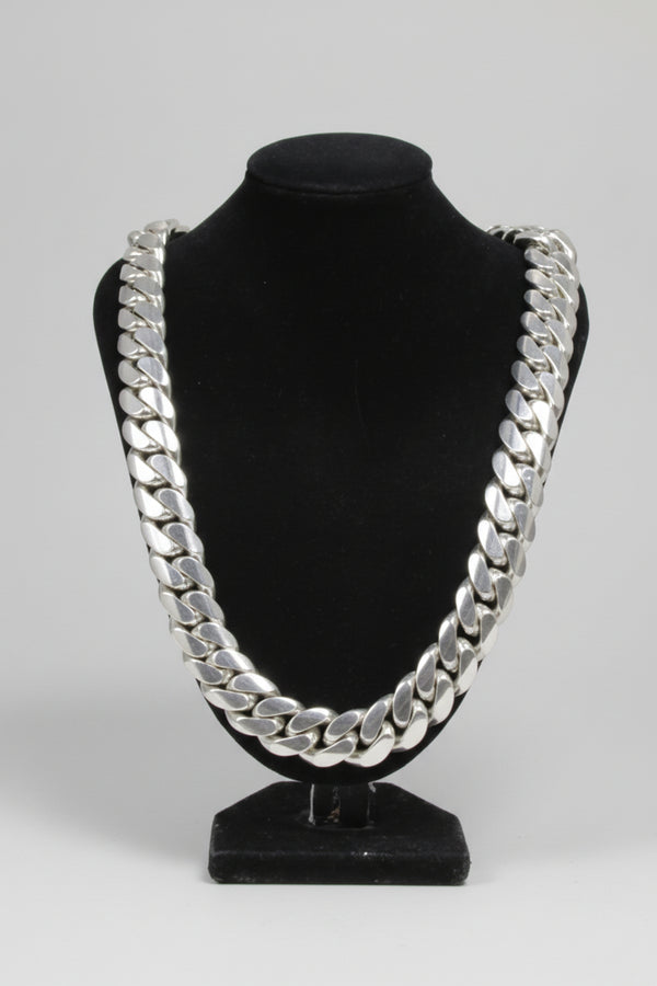 Black headband with silver chain design on a white background