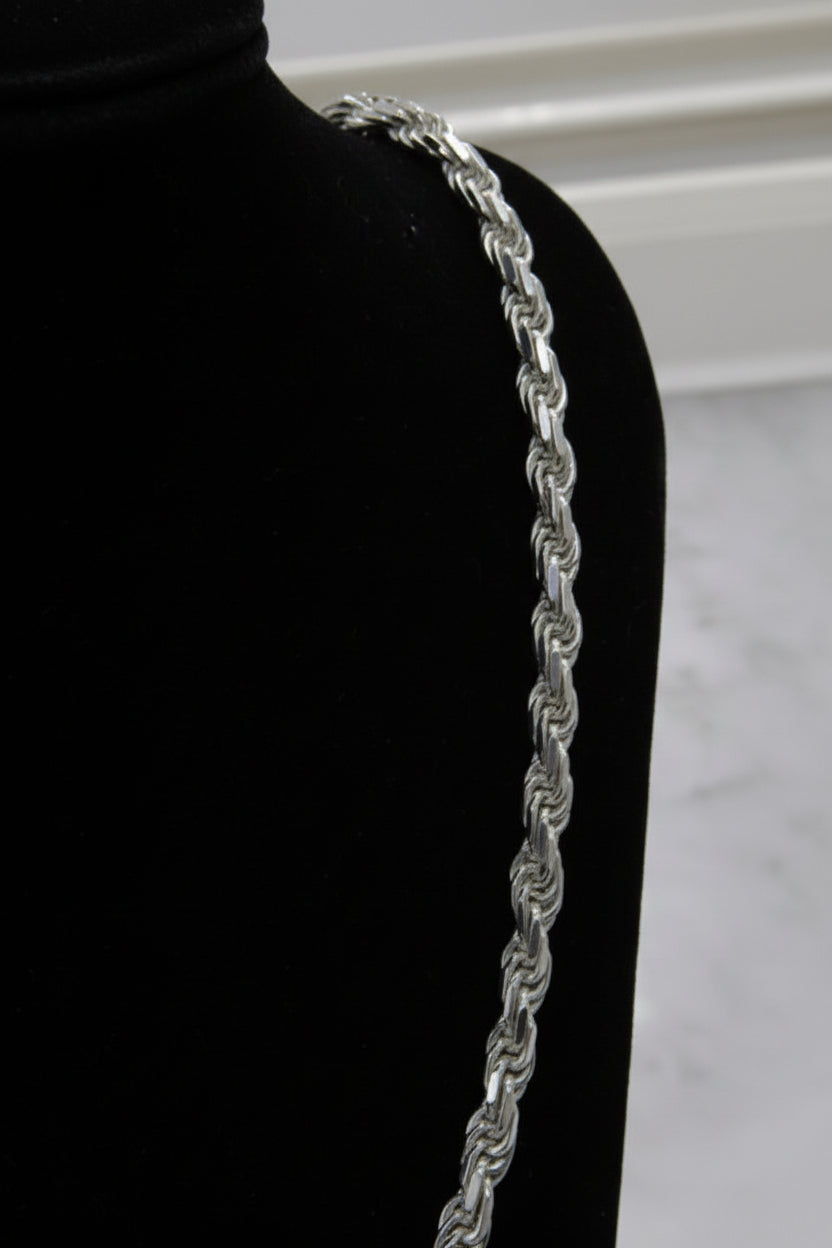 Silver chain belt on a black mannequin with a white background