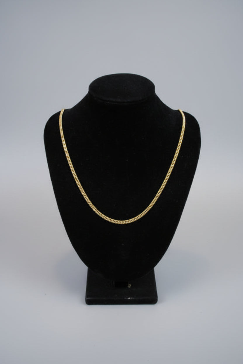 Black hat with gold trim on a mannequin against a white wall