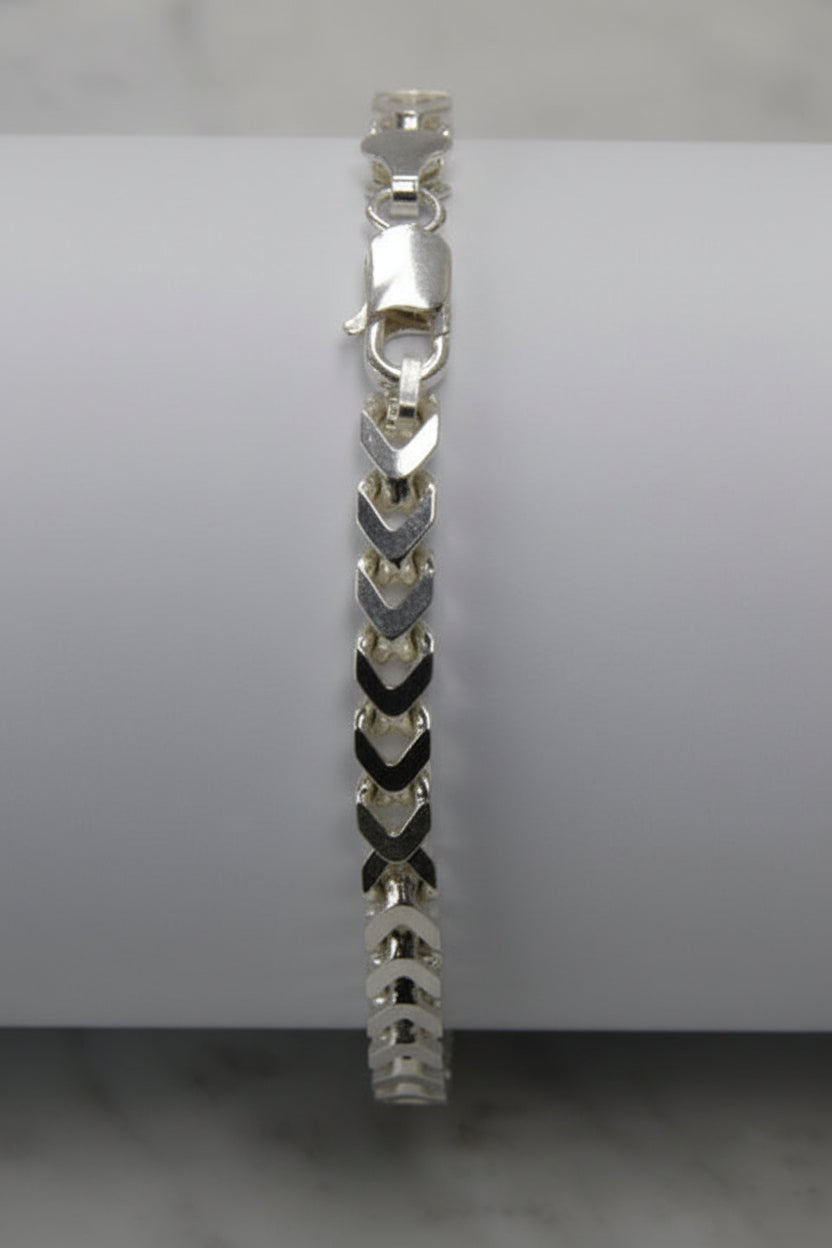Silver bracelet on a light gray background