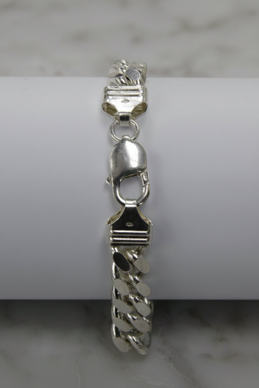 Silver chain bracelet on a light gray background